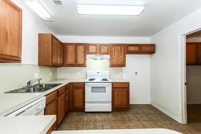 a kitchen with stainless steel appliances granite countertop a sink and cabinets