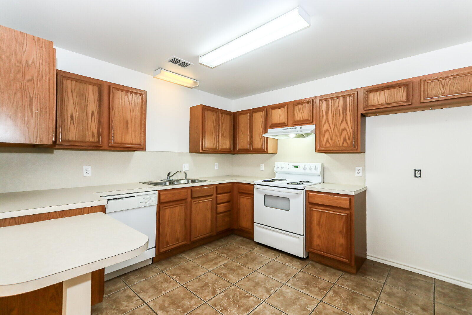 606 North Englewood Avenue, Unit A Lubbock, TX 79416 - Photo 5 of 19 a kitchen with stainless steel appliances granite countertop stove top oven a sink dishwasher and a refrigerator