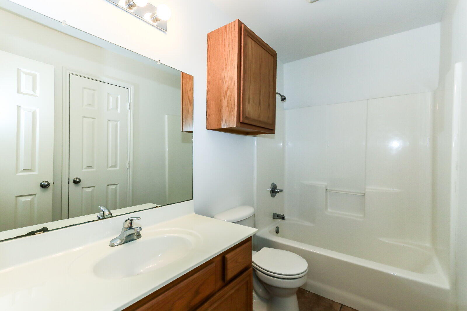 606 North Englewood Avenue, Unit A Lubbock, TX 79416 - Photo 8 of 19 a bathroom with a sink a toilet and shower
