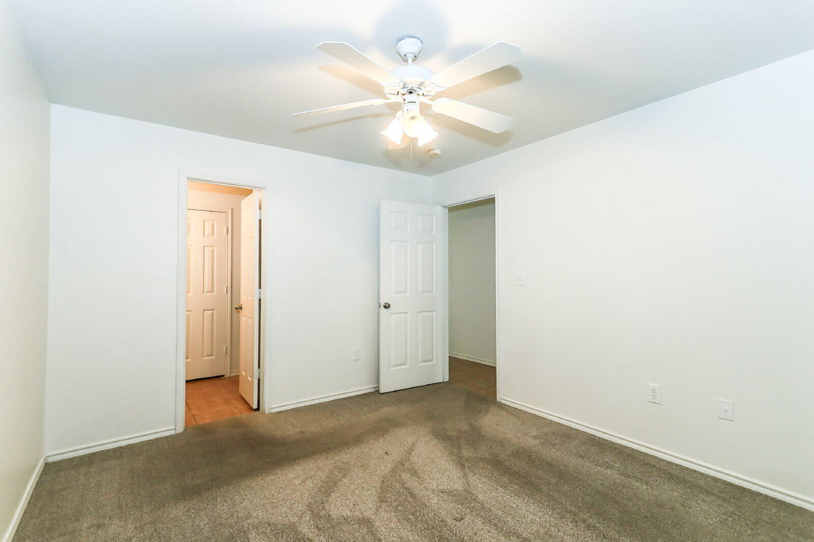 606 North Englewood Avenue, Unit A Lubbock, TX 79416 - Photo 9 of 19 an empty room with a ceiling fan and a window