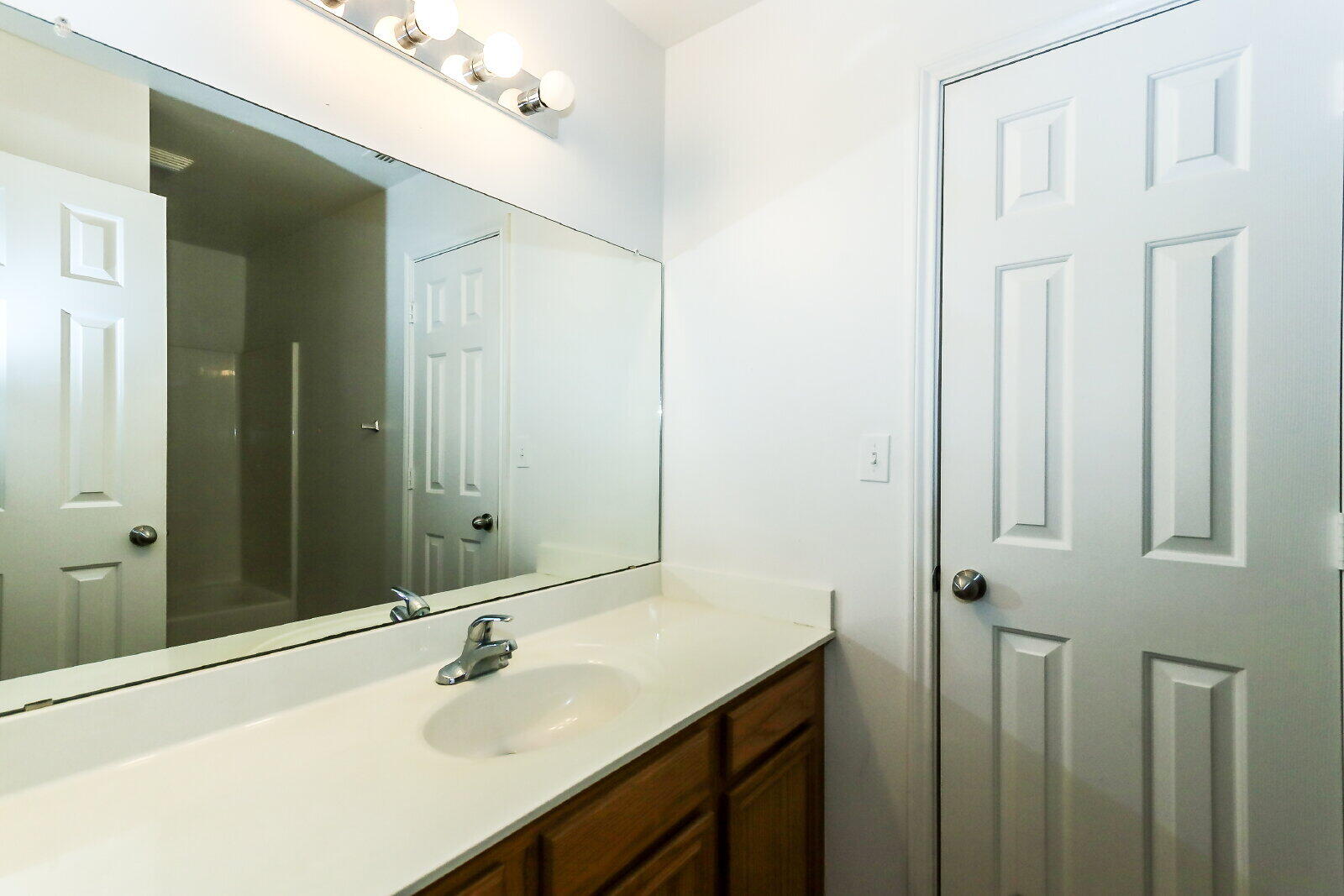 606 North Englewood Avenue, Unit A Lubbock, TX 79416 - Photo 10 of 19 a bathroom with a sink and a mirror