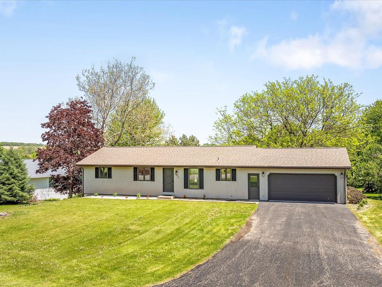 136 Lake Summerset Road Lake Summerset, IL 61019 - Photo 41 of 47 a front view of house with yard and trees in the background