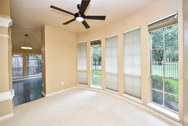 a view of a livingroom with a ceiling fan and window