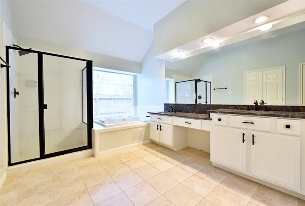 a large bathroom with a large tub and sink