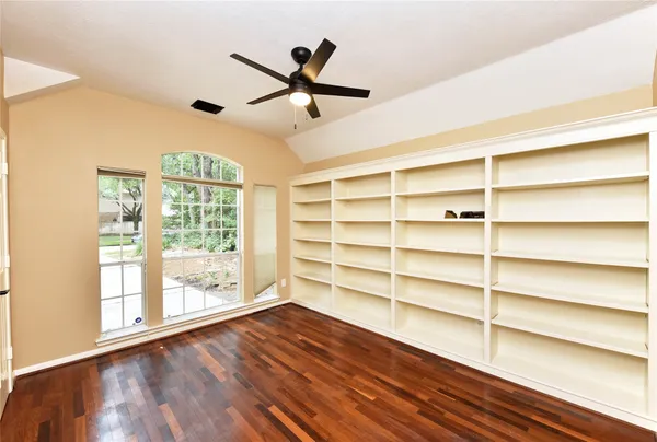 a view of a room with wooden floor and windows