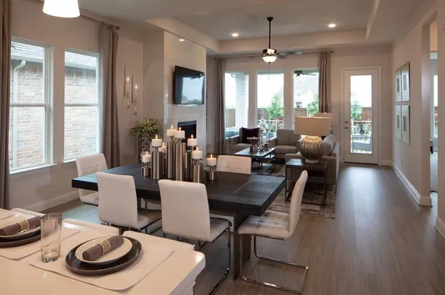 a living room with furniture fireplace and a large window