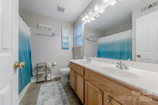 a spacious bathroom with a double vanity sink and a mirror