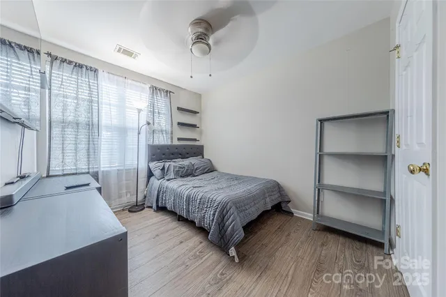 a bedroom with a bed and a large window