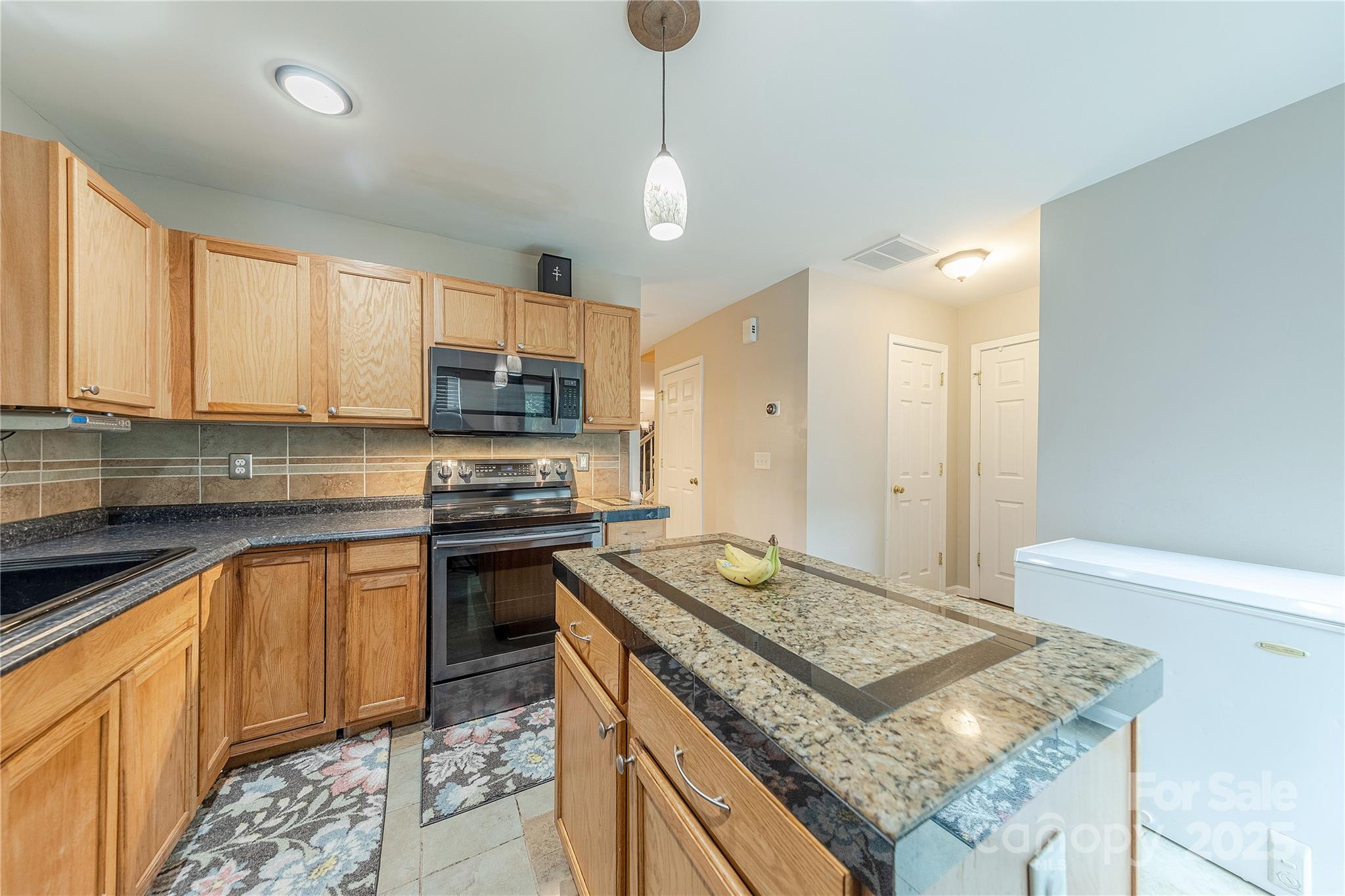 1581 Maypine Commons Way Rock Hill, SC 29732 - Photo 6 of 16 a kitchen with stainless steel appliances granite countertop a stove sink and cabinets