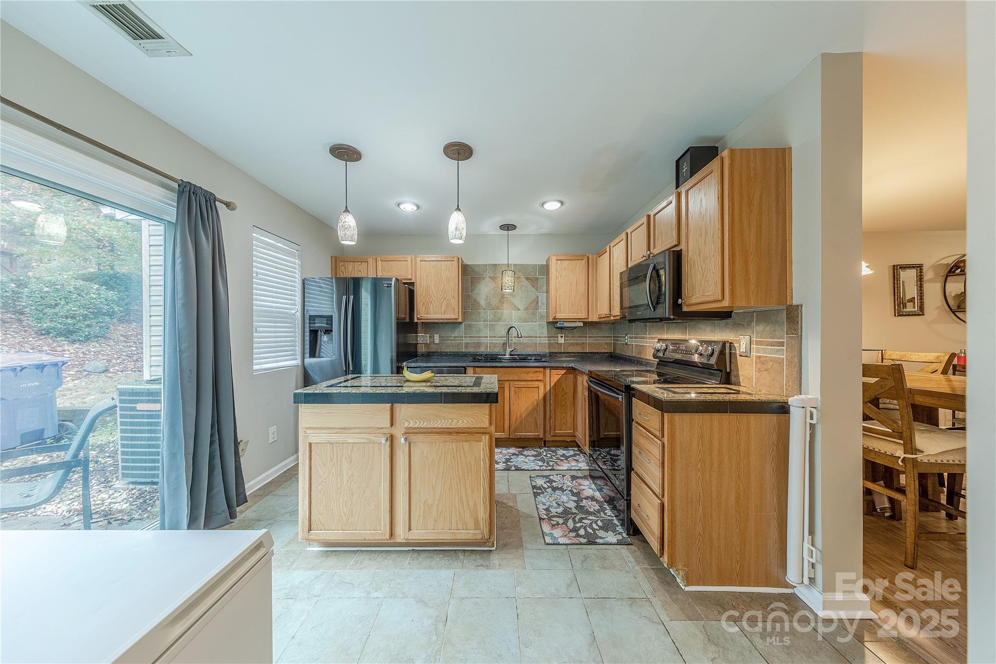 1581 Maypine Commons Way Rock Hill, SC 29732 - Photo 7 of 16 a kitchen with stainless steel appliances granite countertop a stove a sink a refrigerator and a cabinets
