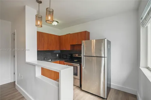 a kitchen with stainless steel appliances a refrigerator a stove a sink and a refrigerator