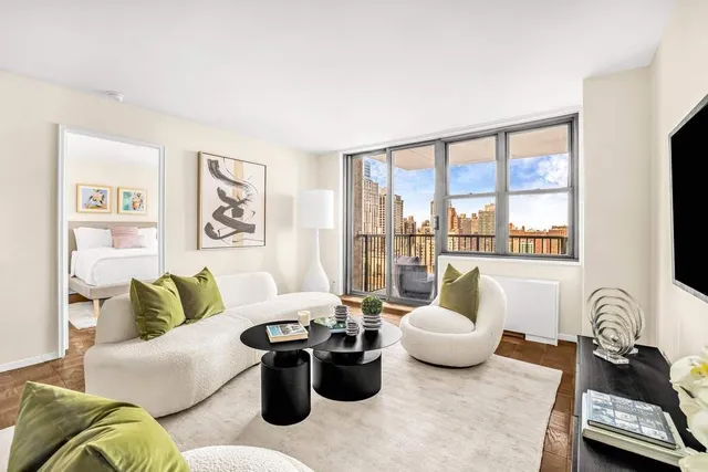 a living room with furniture and a floor to ceiling window