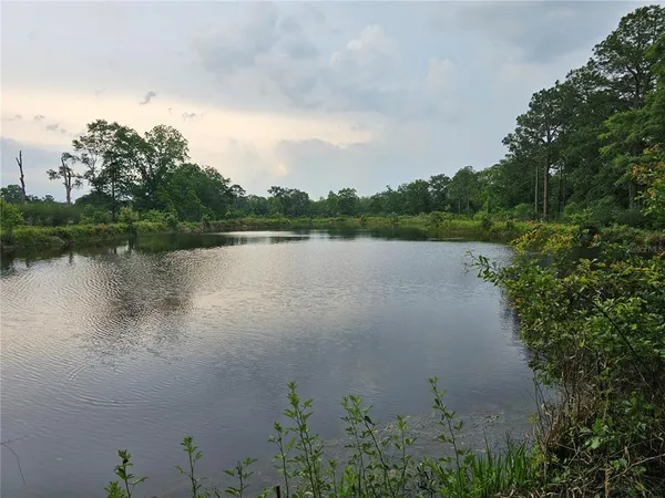 a view of a lake with houses in the back