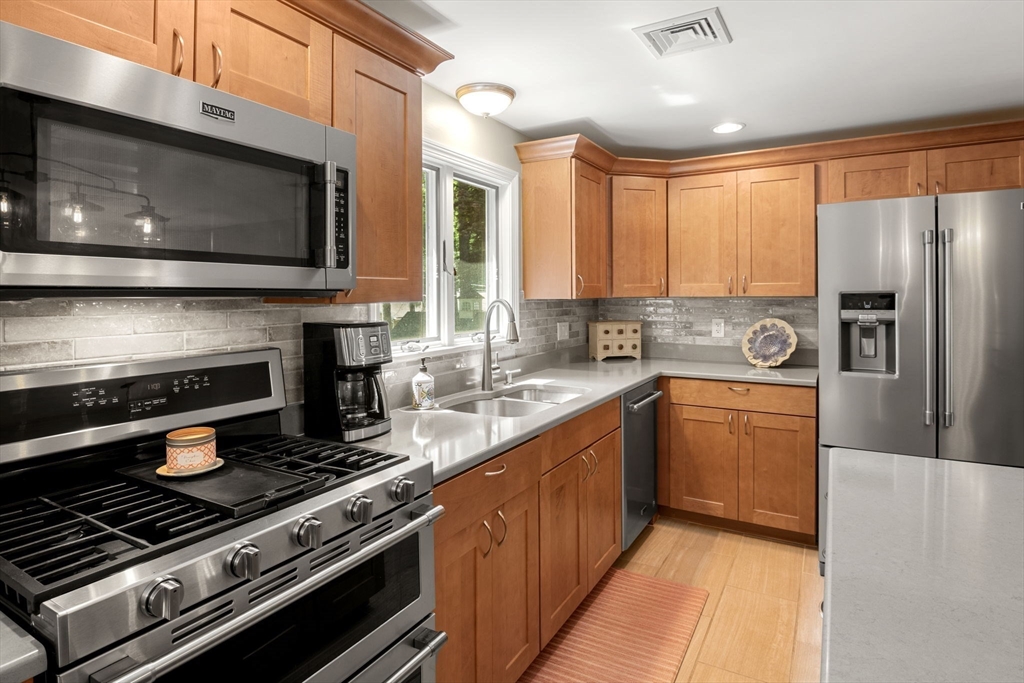 13 Spring Street Danvers, MA 01923 - Photo 14 of 39 a kitchen with stainless steel appliances a stove a microwave and a sink