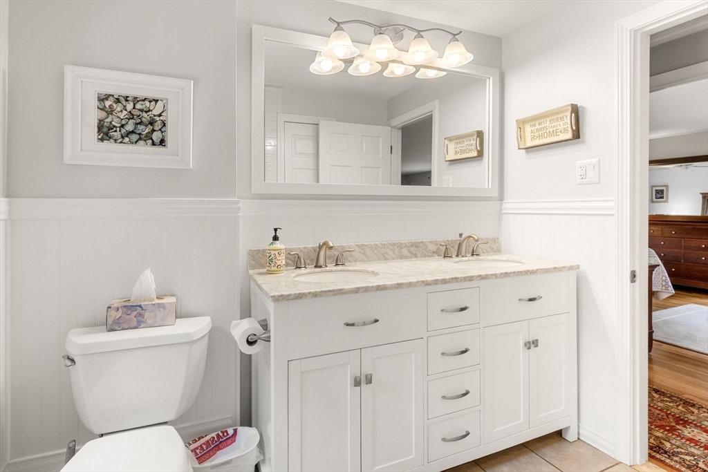 13 Spring Street Danvers, MA 01923 - Photo 16 of 39 a bathroom with a toilet sink and mirror