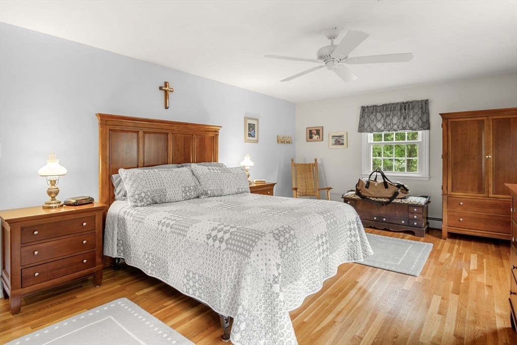 13 Spring Street Danvers, MA 01923 - Photo 18 of 39 a bedroom with a bed and wooden floor