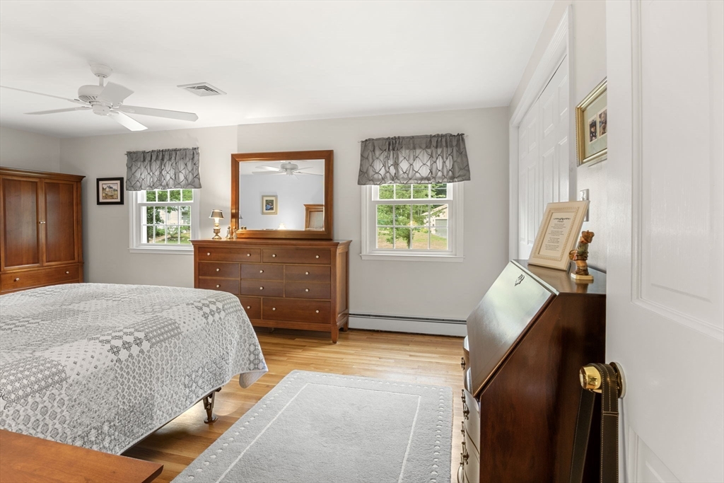 13 Spring Street Danvers, MA 01923 - Photo 19 of 39 a bedroom with a bed and a dresser next to a window