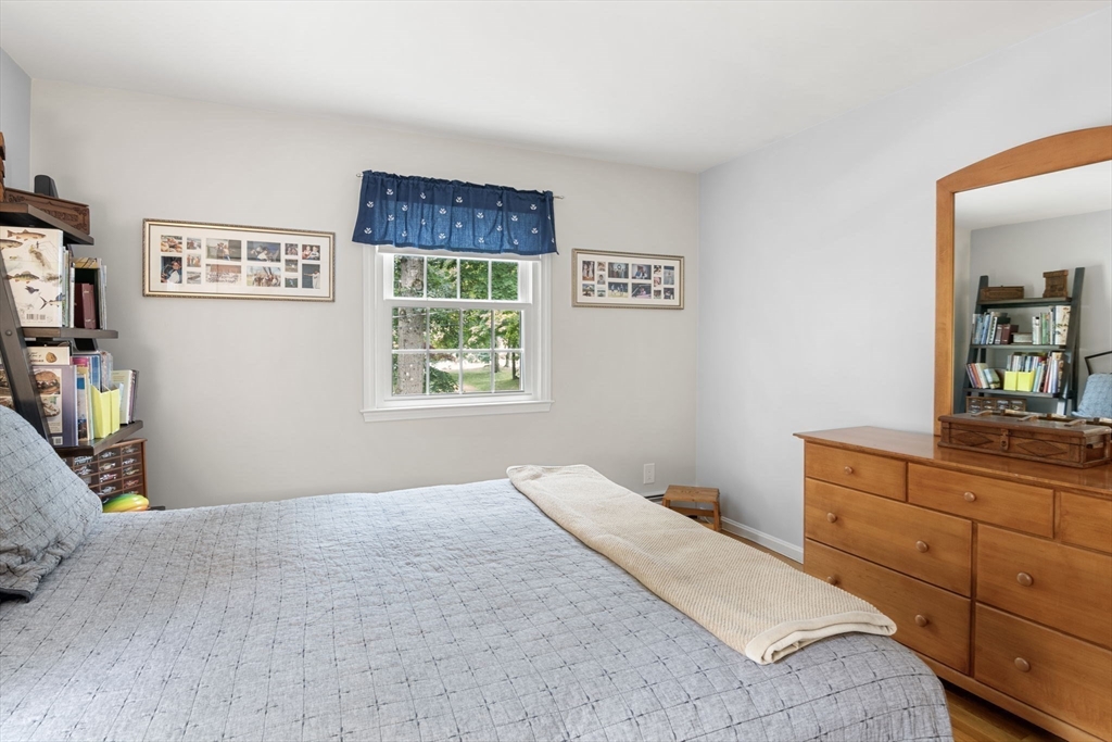 13 Spring Street Danvers, MA 01923 - Photo 22 of 39 a bedroom with a bed and a dresser in it