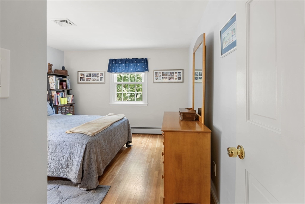 13 Spring Street Danvers, MA 01923 - Photo 23 of 39 a bedroom with a bed and a dresser in it
