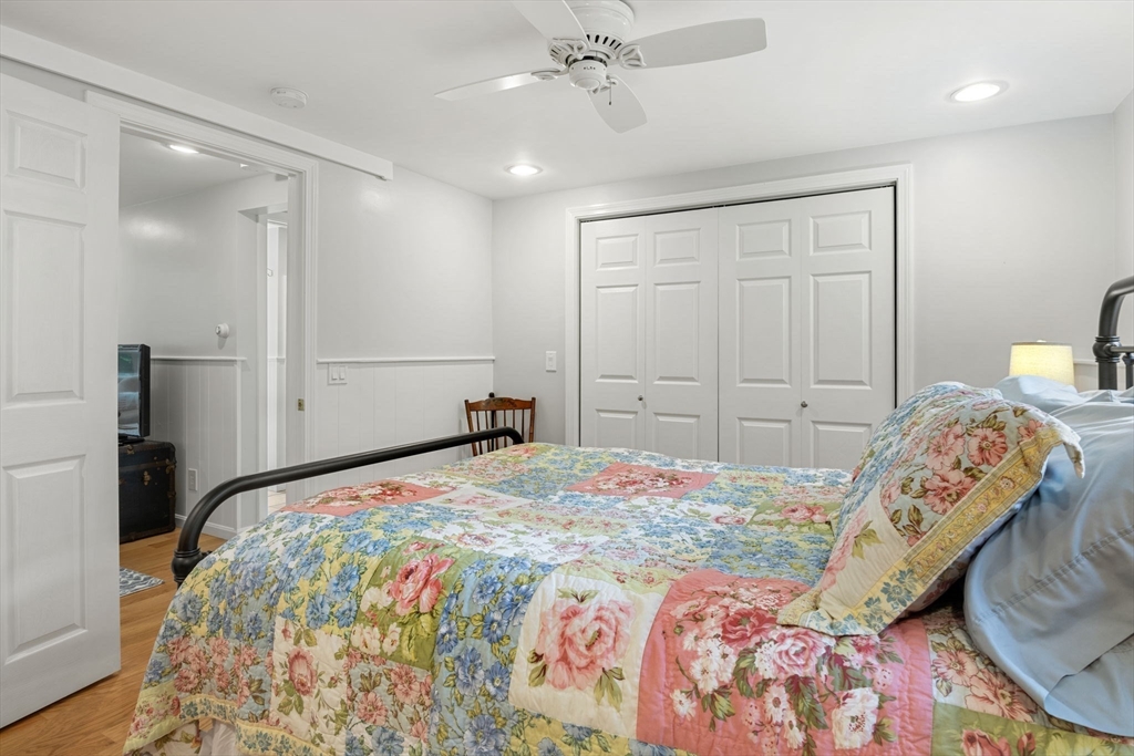 13 Spring Street Danvers, MA 01923 - Photo 25 of 39 a bedroom with a bed and a chandelier