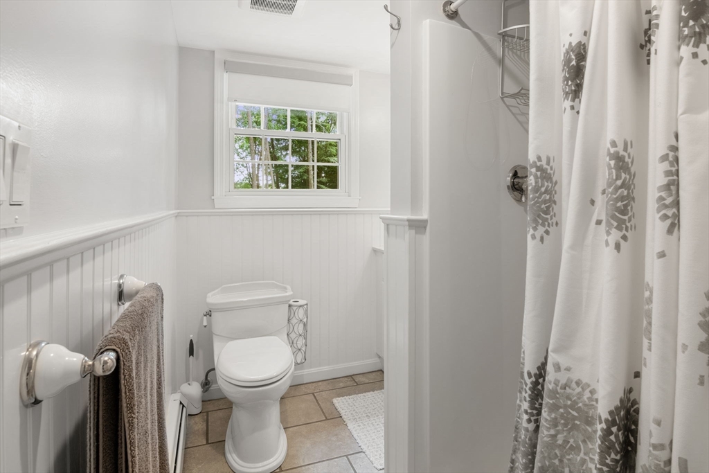13 Spring Street Danvers, MA 01923 - Photo 30 of 39 a white toilet sitting next to a bathroom sink and a window