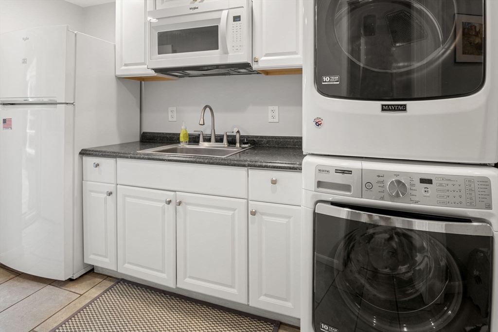 13 Spring Street Danvers, MA 01923 - Photo 31 of 39 a utility room with sink dryer and washer