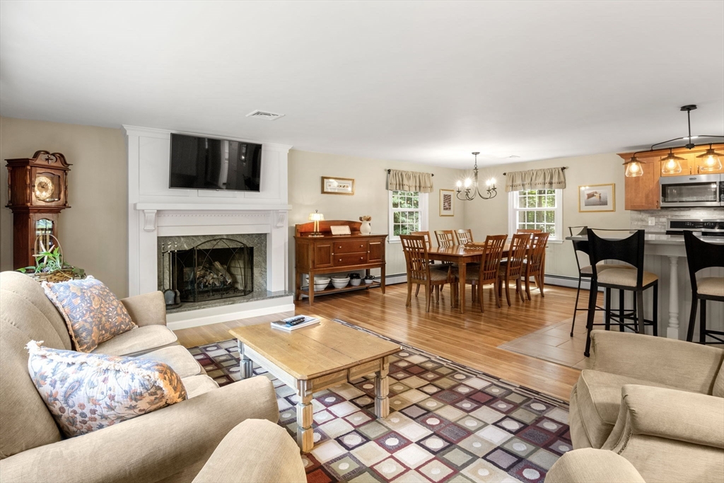 13 Spring Street Danvers, MA 01923 - Photo 7 of 39 a living room with furniture a dining table and a fireplace