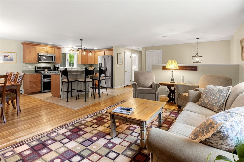 13 Spring Street Danvers, MA 01923 - Photo 8 of 39 a living room with furniture and a dining table with wooden floor