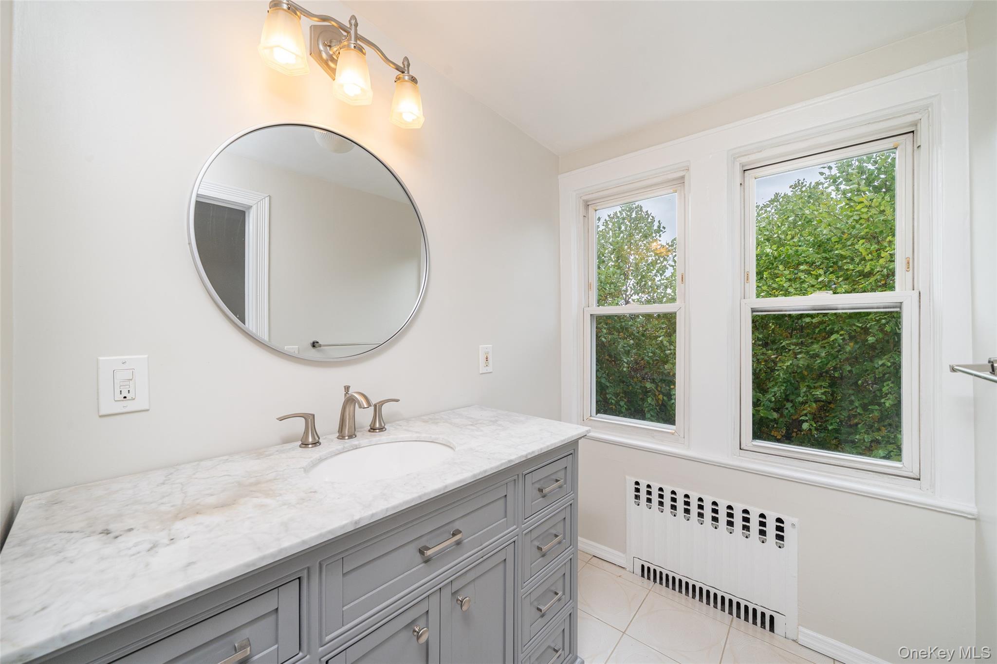 45 Chestnut Street Tuckahoe, NY 10707 - Photo 18 of 27 Bathroom featuring radiator, vanity, and light tile patterned floors