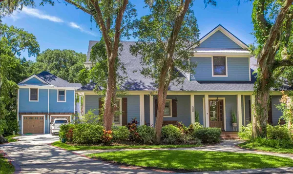 front view of a brick house with a yard