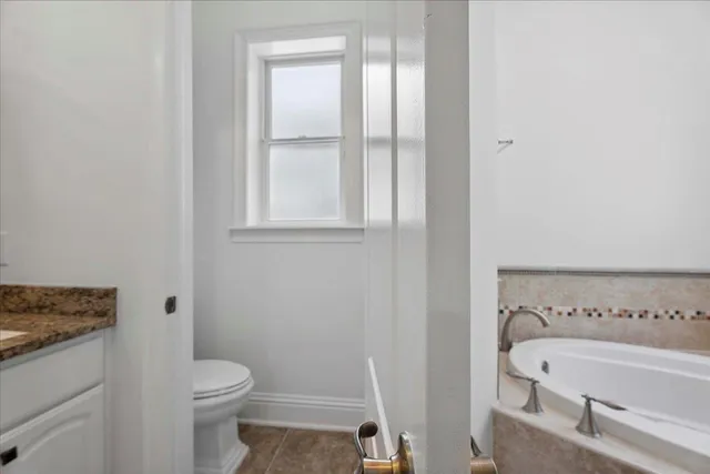 a front view of a house with a yard and potted plants