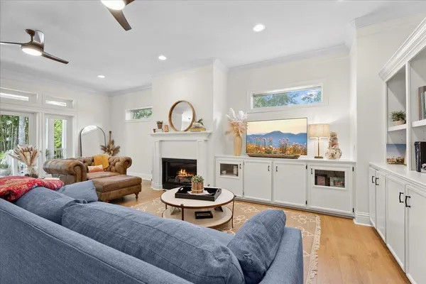 a living room with furniture kitchen view and a fireplace