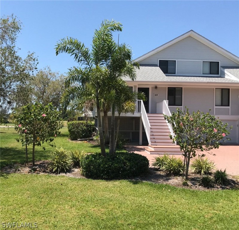 1627 Sand Castle Road Sanibel, FL 33957 - Photo 2 of 3 a front view of a house with a yard