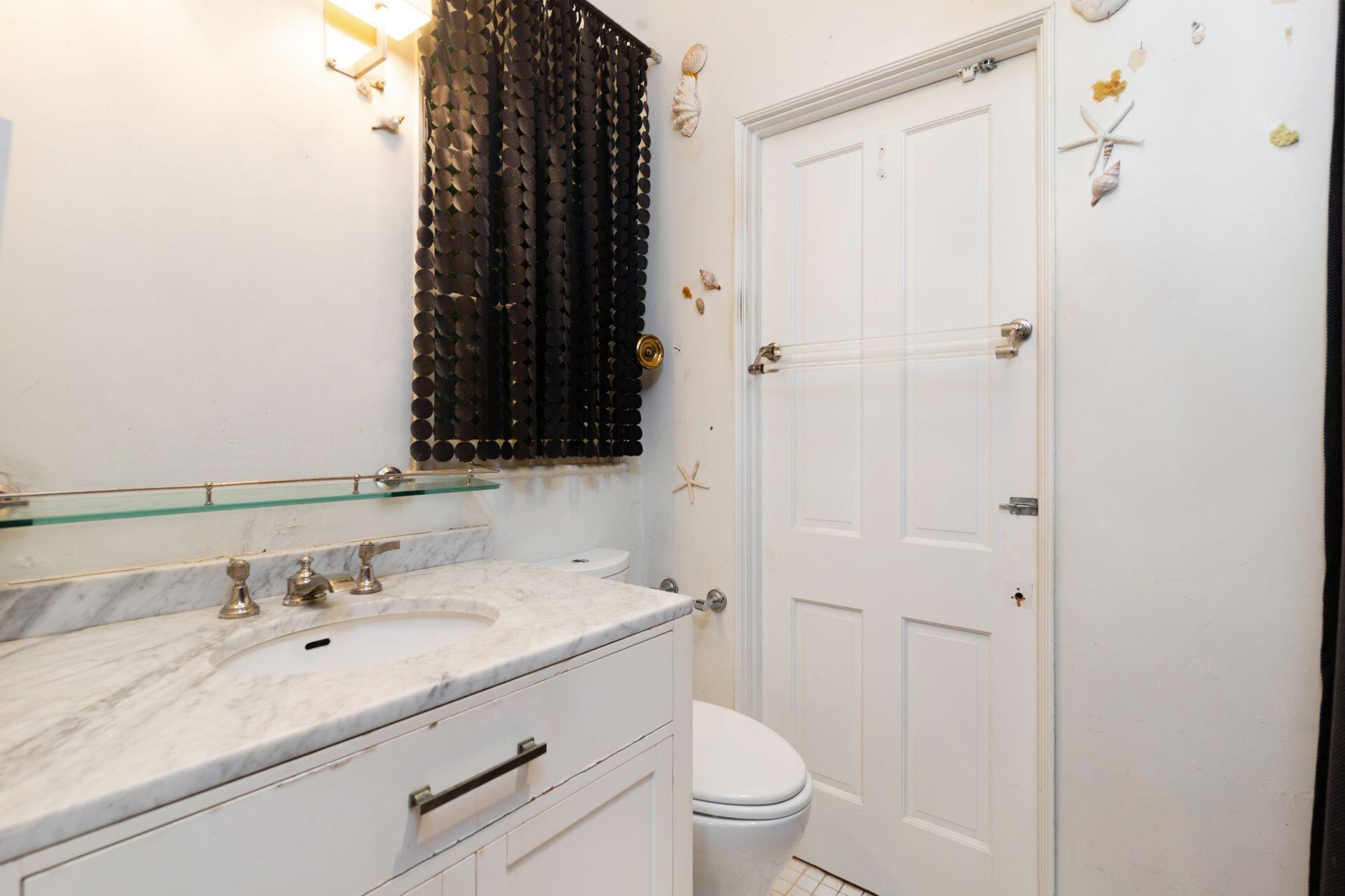 228 Phipps Plaza Palm Beach, FL 33480 - Photo 11 of 24 a bathroom with a granite countertop sink toilet and shower