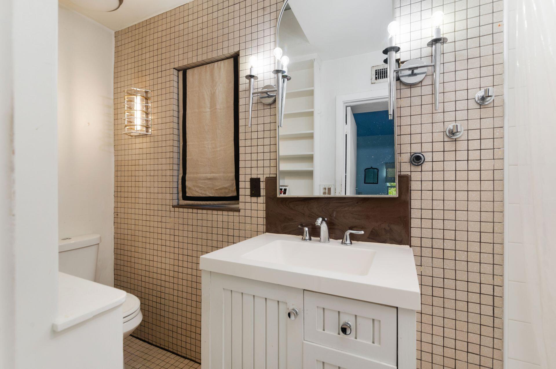 228 Phipps Plaza Palm Beach, FL 33480 - Photo 15 of 24 a bathroom with a sink a toilet and shower