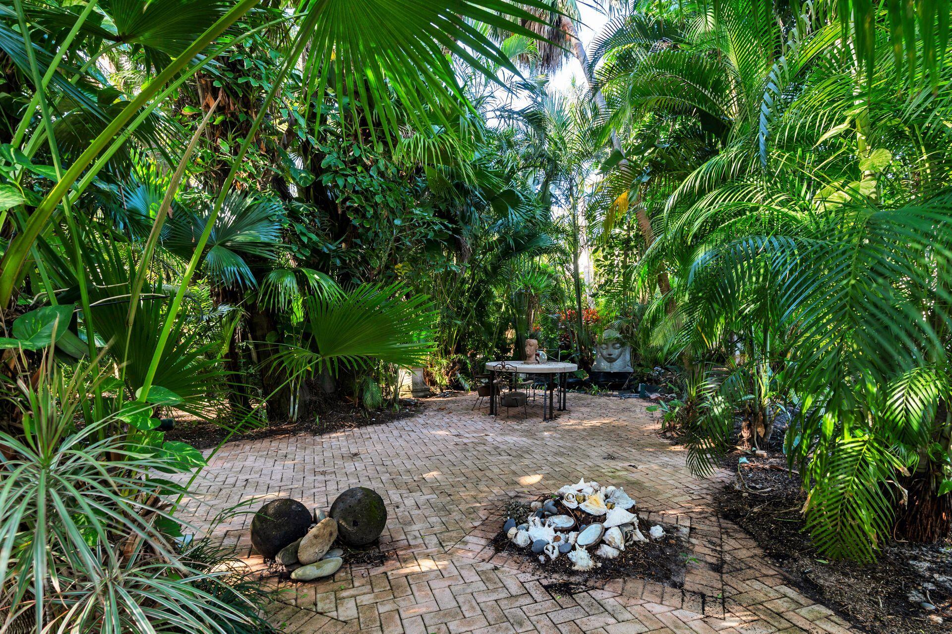 228 Phipps Plaza Palm Beach, FL 33480 - Photo 20 of 24 a view of a chairs and fire pit in a backyard