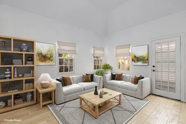 a living room with furniture a rug and a table