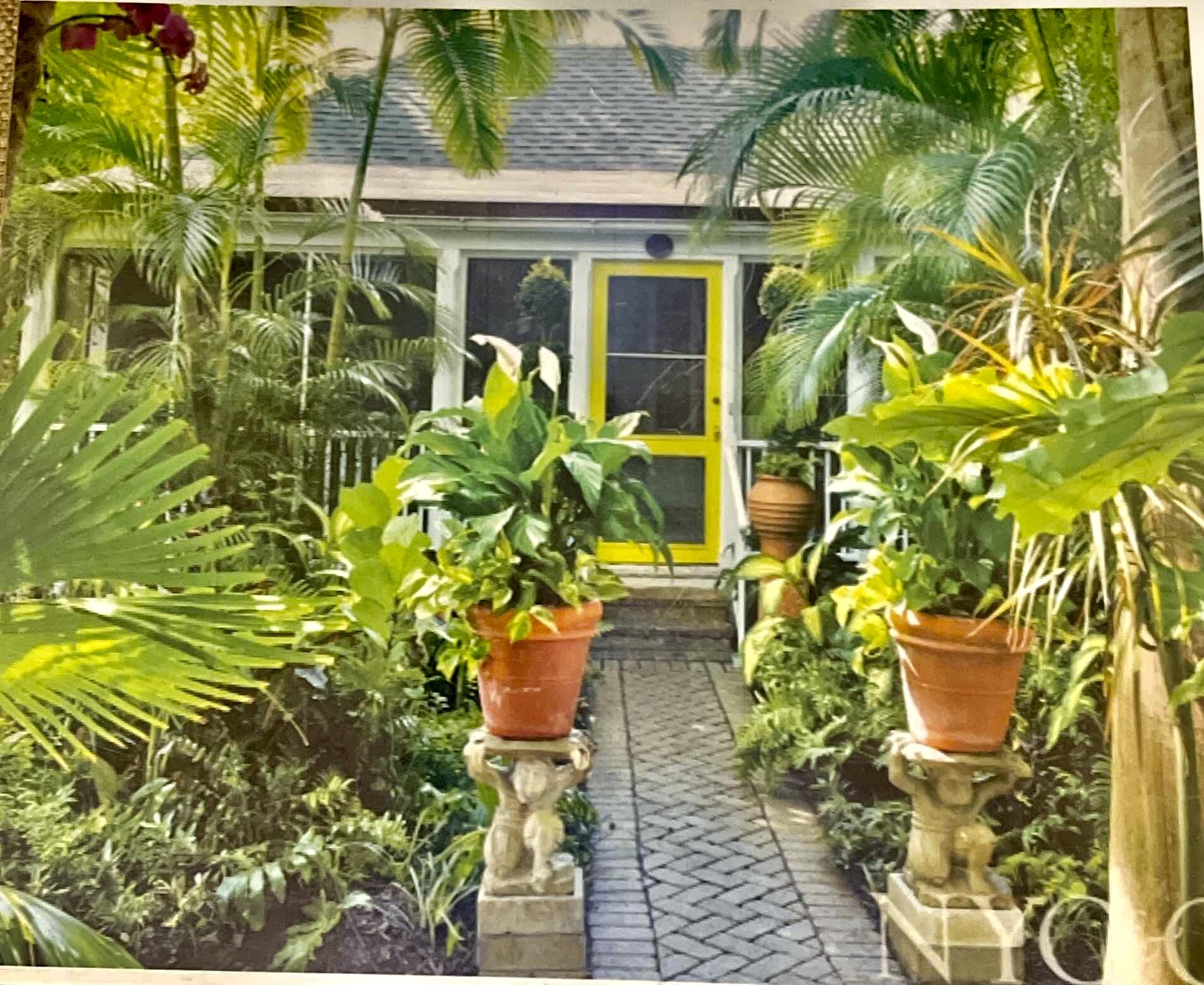 228 Phipps Plaza Palm Beach, FL 33480 - Photo 5 of 24 a potted plant is sitting in front of a yellow house