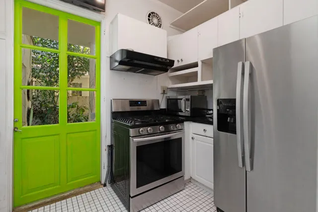 a kitchen with a stove cabinets and a refrigerator