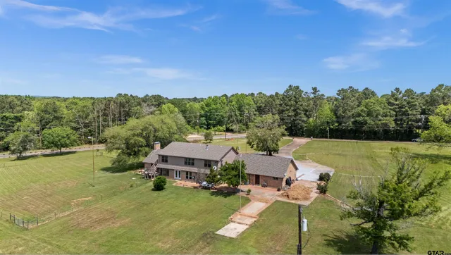 a aerial view of a house with pool garden view and lake view
