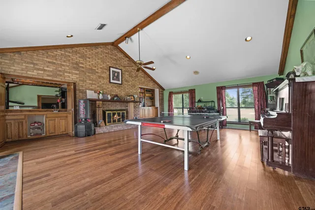 a living room with fireplace furniture and a wooden floor