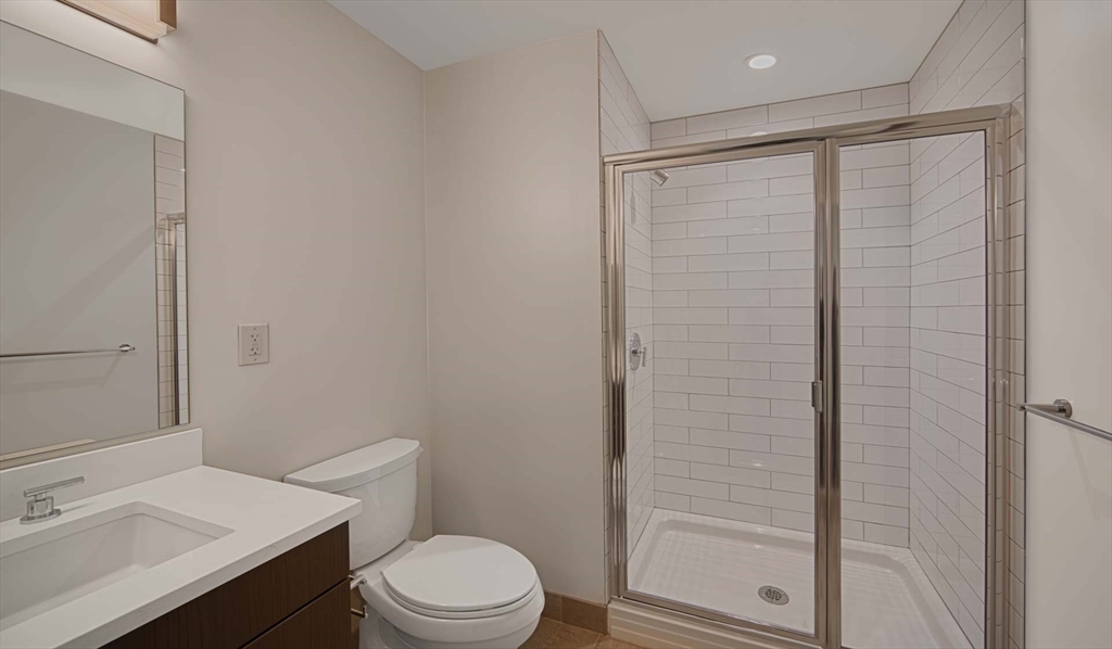 1 Canal Street, Unit 936 Boston, MA 02114 - Photo 4 of 11 a bathroom with a sink a toilet and shower