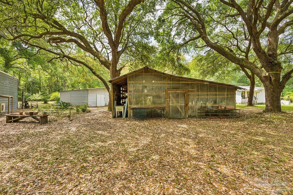 8938 Pioneer Road Holt, FL 32564 - Photo 36 of 44 a view of a house with a yard