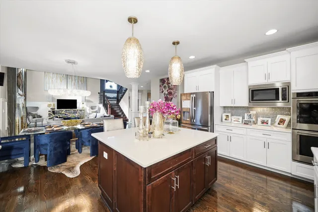 a kitchen with kitchen island a sink stove and refrigerator