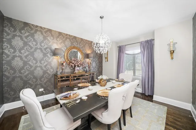 a dining room with furniture a chandelier and window