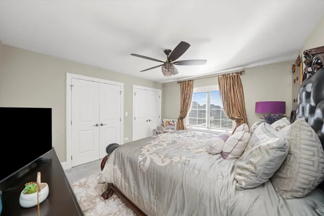 a bedroom with a bed furniture and a large window