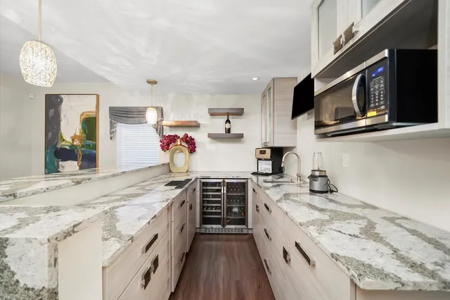 a view of kitchen dining table and chairs with wooden floor