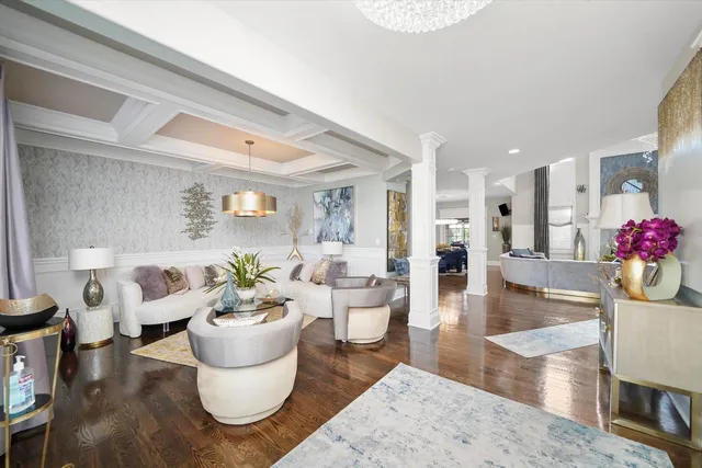 a living room with furniture and a dining table