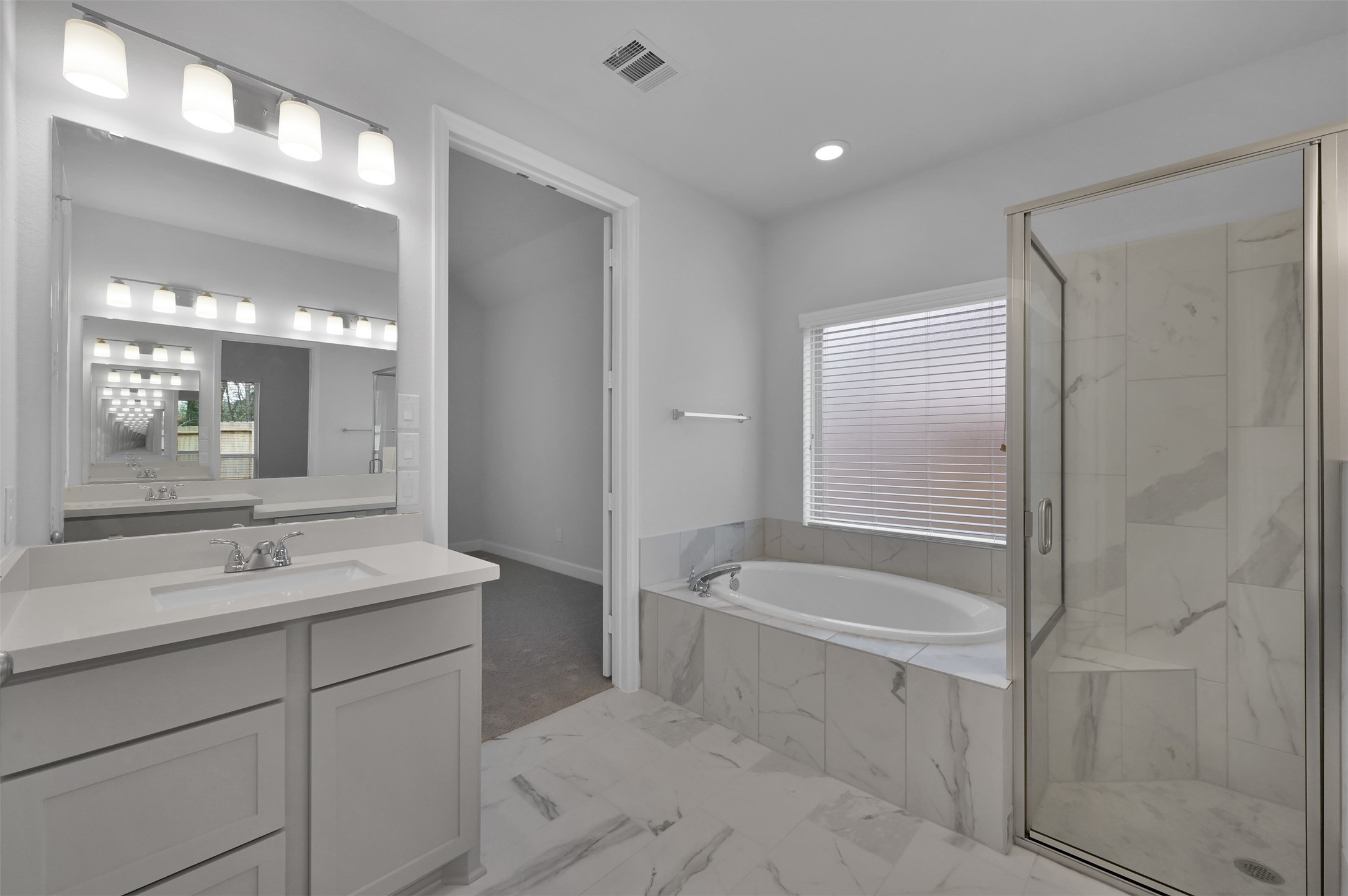 15715 Autumn Sun Conroe, TX 77302 - Photo 16 of 23 a bathroom with a tub a sink and mirror