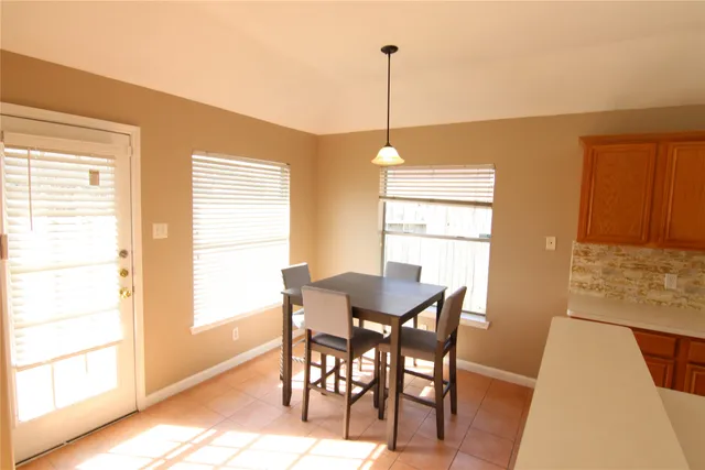 a view of a dining room with furniture and a window